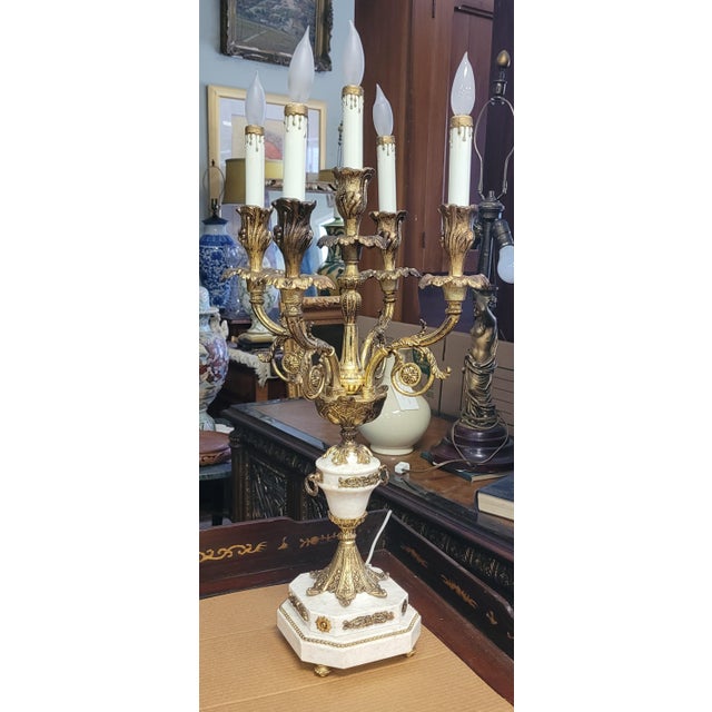 A beautiful pair of French style stone or marble and Gilt brass candelabras dating to the mid-century 1950s. Each measures...
