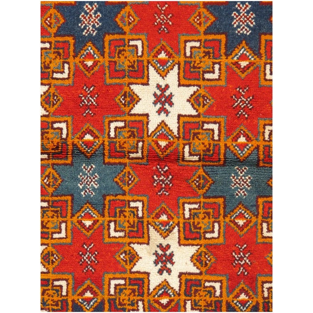 Vintage Moroccan hand-knotted wool rug with bold pattern and low pile.
