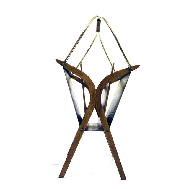 This magazine stand is made of bentwood, plywood and brass. The handle features raffia winding and plastic. It is...