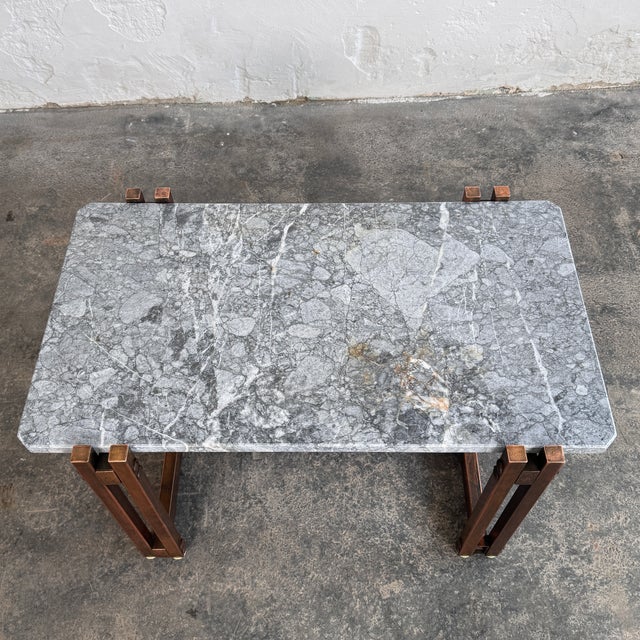 This mid-century modern coffee table is a sophisticated statement piece, blending the timeless luxury of natural stone...