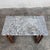 This mid-century modern coffee table is a sophisticated statement piece, blending the timeless luxury of natural stone...