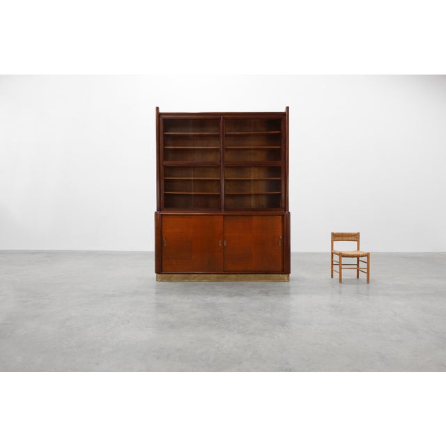 A commanding presence from the early years of Belgian Art Deco, this large apothecary cabinet; attributed to the esteemed...