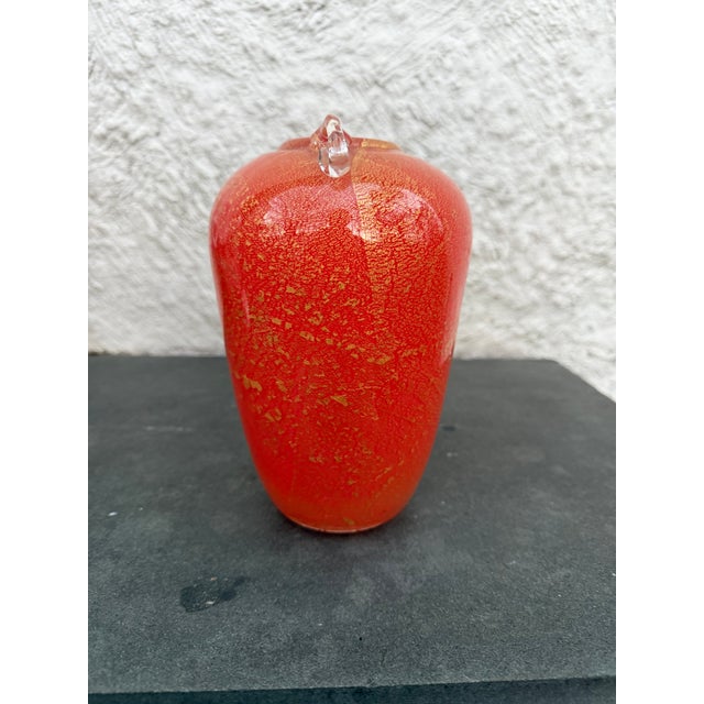 Hand blown orange glass urn shaped vase with gold flecks attributed to Isle of Wight Glass Studios. There are no makers...