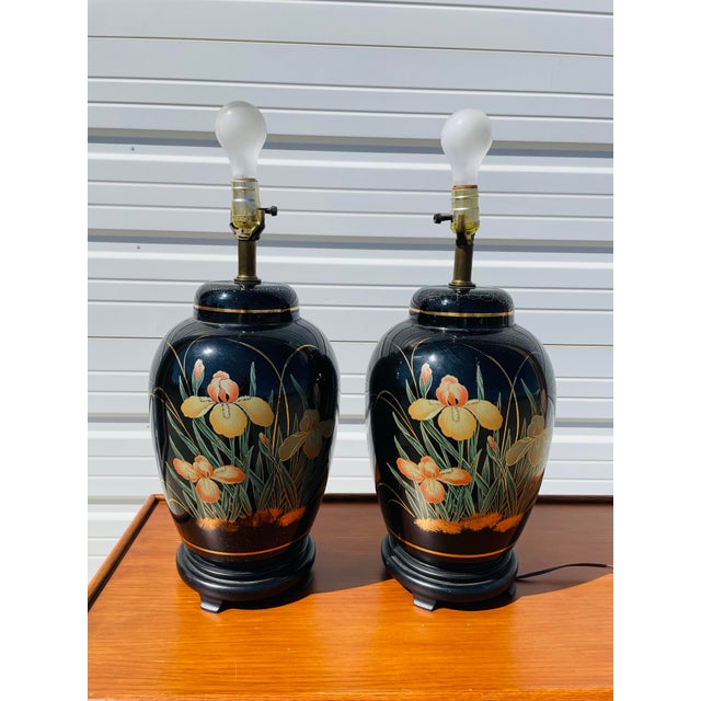 Beautiful pair or mid century Asian ginger jar style lamps. Black glazed porcelain with exceptionally detailed floral...
