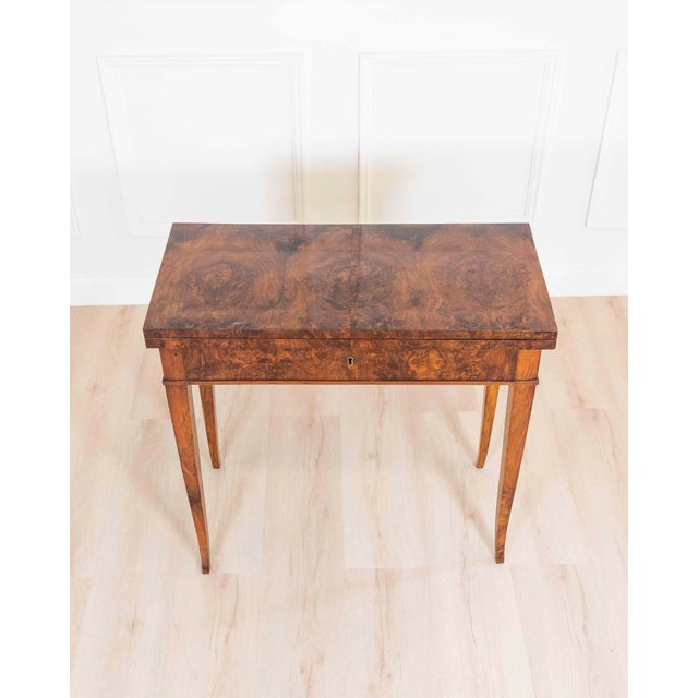 A handsome Italian Directoire game table dating to circa 1800, beautifully veneered in richly figured walnut burl, prized...