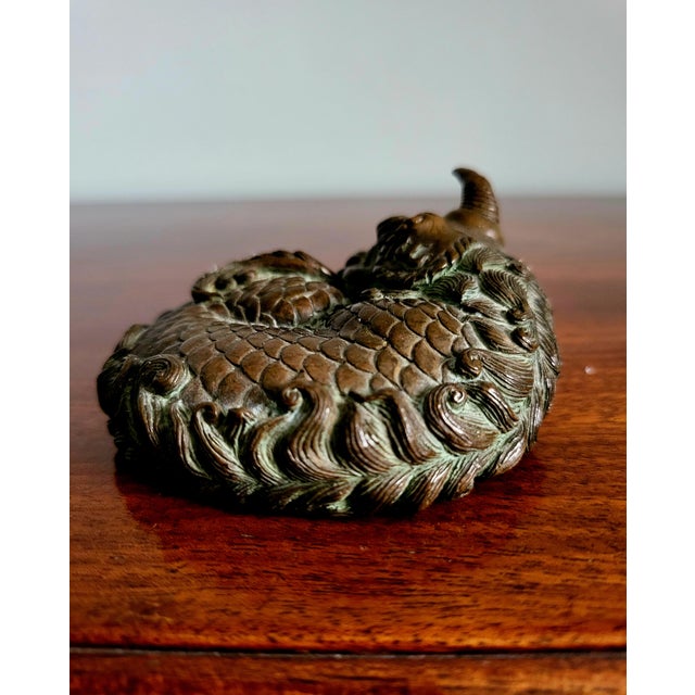 A masterclass in the naturalistic philosophy of Japan's Meiji period (1868–1912), this exquisite cast-bronze paperweight...