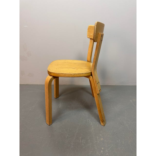 Authentic set of three first-edition Alvar Aalto Model 69 dining chairs with nice patina, produced by Artek Finland....