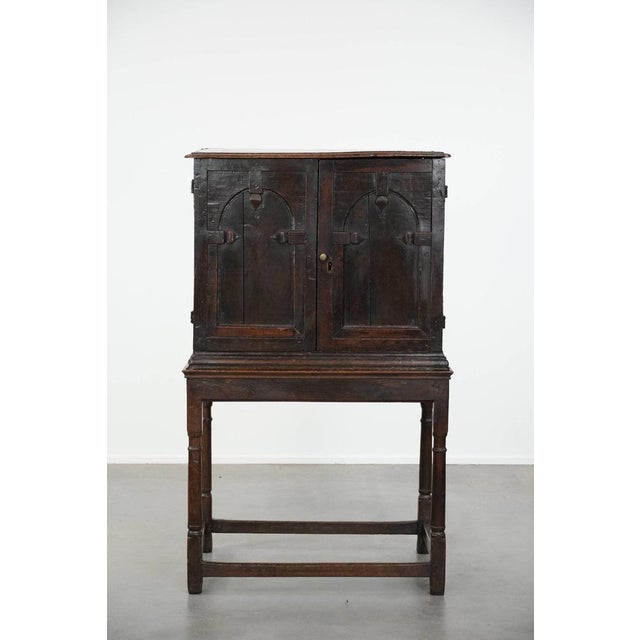 We are offering this unique antique English oak cabinet on stand from the 17th century with beautiful original details. A...