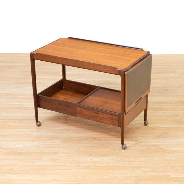 Designed by Ib Kofod-Larsen for G-Plan's highly sought-after Danish range, this elegant mid-century teak drinks trolley...