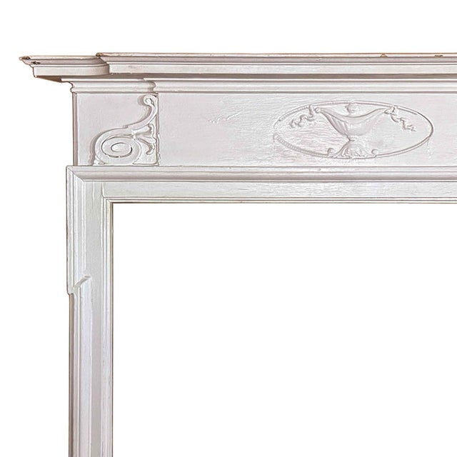 Antique, early 20th century Federal painted fireplace mantel having a a central frieze with a carved oval tablet depicting...