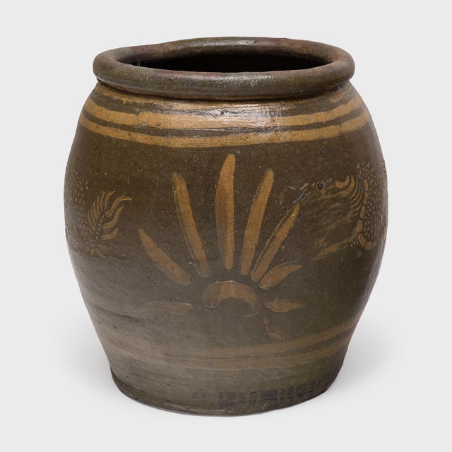 This vintage stoneware pot is decorated with a charming design of twin celestial dragons. Applied with white clay slip and...