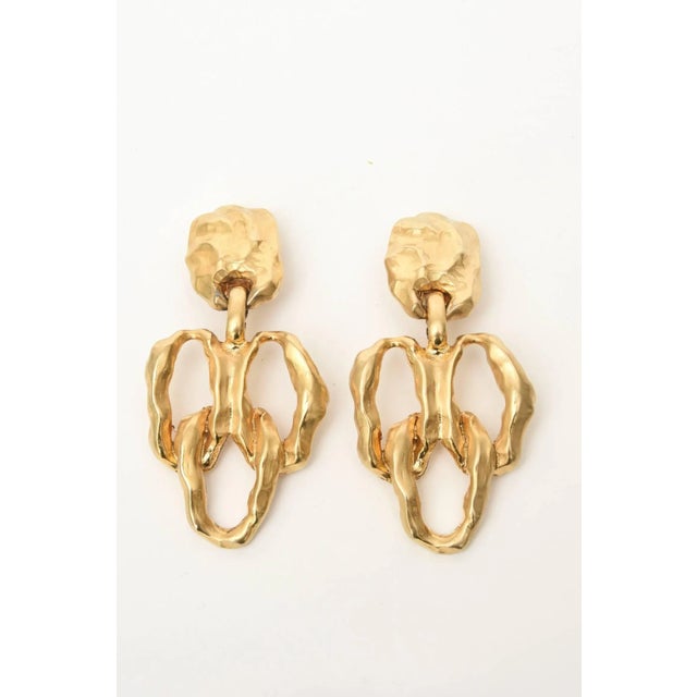 This is part of Chairish’s Costume Jewelry assortment. These handsome and lovely pair of gold-plated dangle earrings make...