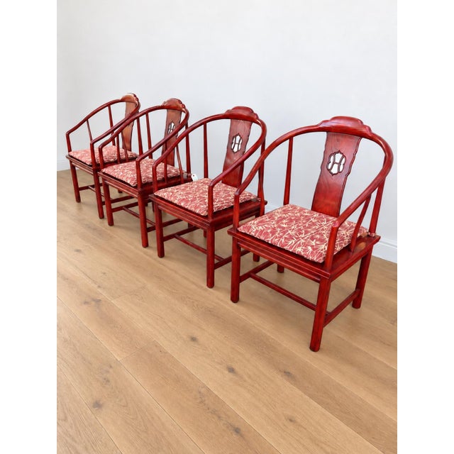 Chinese Horseshoe Back Arm chairs. Known as Quanyi Chairs. Wood is stained a deep Chinese red. Palm Pattered seat cushions...