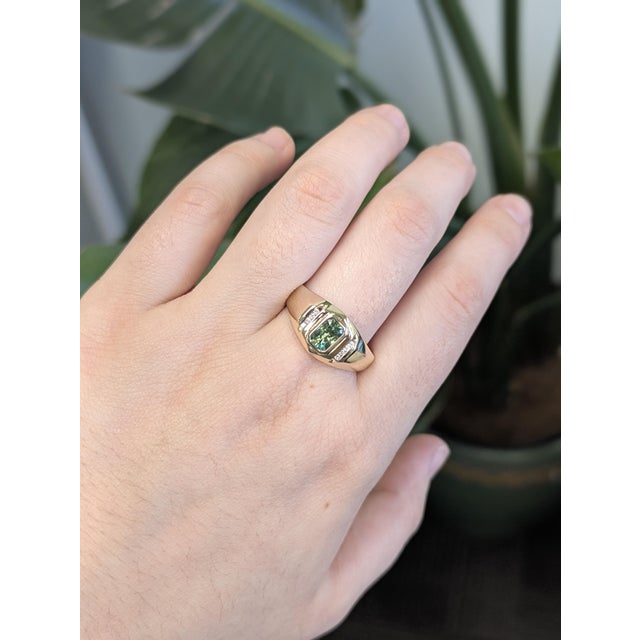 Radiating rare brilliance, this emerald-cut 6x4mm Demantoid from the famed Green Dragon Mine is accented with natural...