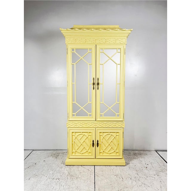 Vintage chinoiserie Chinese chippendale pagoda cabinet. Mirror front doors open to lit shelves and interior drawer. Bottom...