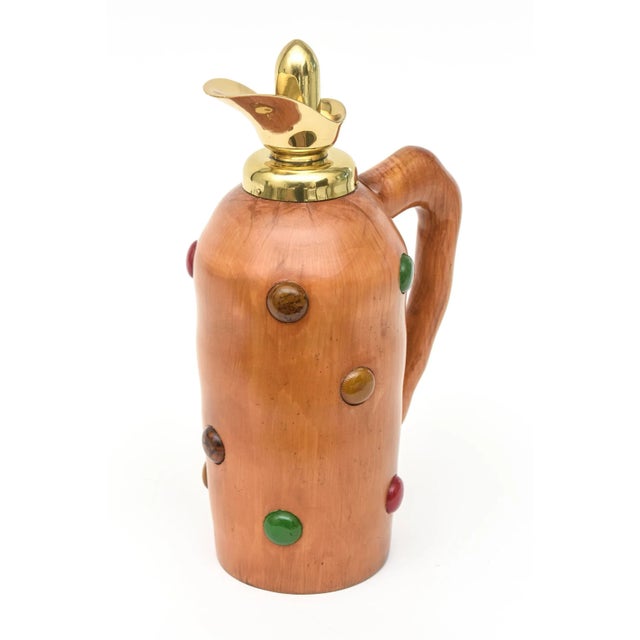 This mid century modern Italian jug/ decanter is in the style of Aldo Tura. It is beautiful wood with interspersed dots of...