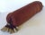 This chocolate brown silk bolster pillow is tied off at both ends with a silver silk scrunch tie and the ends are finished...