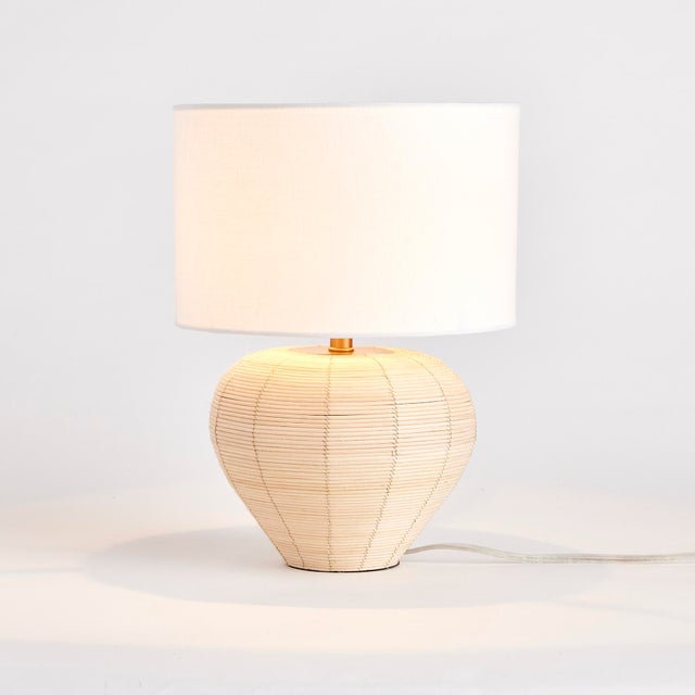Woven in a natural cane rattan, with subtle variations in color making each one truly unique, this mini lamp is an instant...