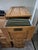 This is a vintage or antique 4-drawer vertical filing cabinet made of solid oak, featuring raised-panel drawer fronts,...