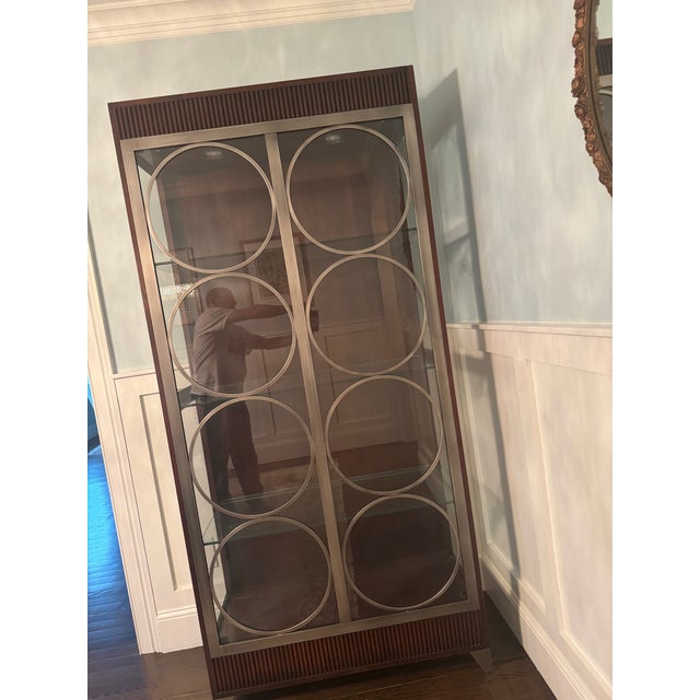 Gorgeous dark mahogany frame contrasted with stainless steel or pewter-finished circular overlays. Interior interior glass...