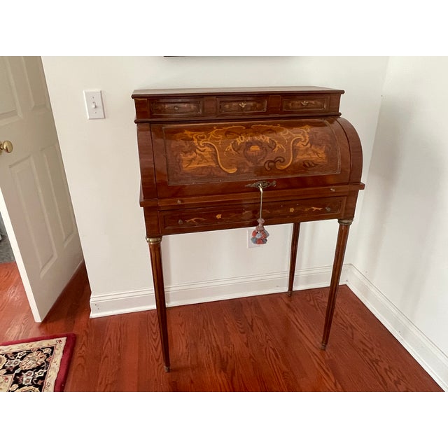 Elegant French cylinder (tambour) writing desk featuring beautiful marquetry inlay across the roll-top and drawer fronts....