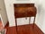 Elegant French cylinder (tambour) writing desk featuring beautiful marquetry inlay across the roll-top and drawer fronts....