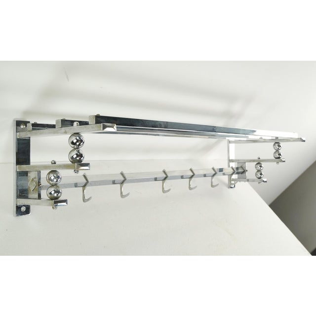 Vintage European train rack made of brass and steel with a chrome finish. It features a top shelf and six hooks. The...