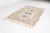 This is a vintage Turkish Oushak rug from the Mid 20th Century. The piece was hand-knotted.