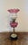 Outstanding quality antique Victorian cranberry glass oil lamp having the original pink glass shade with a wavy shaped top...