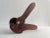 A handcrafted solid walnut wood nutcracker crafted with soft curves. This piece is sculptural and functional.