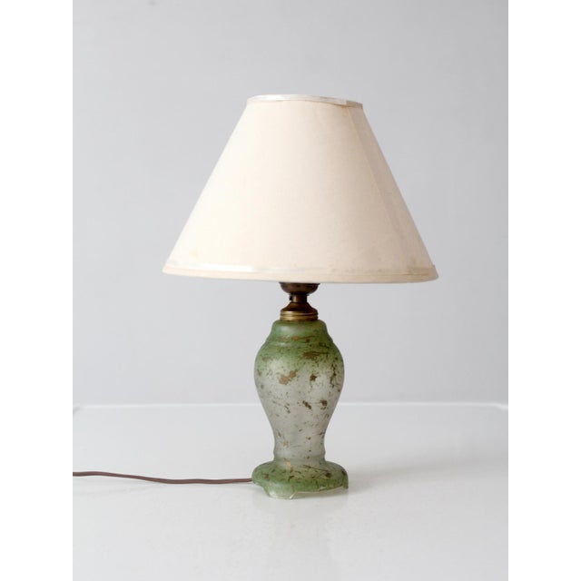 Vintage 1930s glass table lamp with a graceful urn form in translucent green glass, accented with softly worn gold-painted...