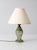 Vintage 1930s glass table lamp with a graceful urn form in translucent green glass, accented with softly worn gold-painted...