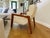 Modern contemporary lounge chair by Opulence Home featuring a sculptural wood frame with cream upholstered cushions. This...