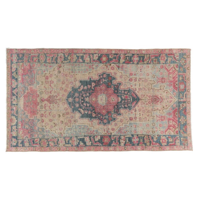 This beautiful vintage tribal rug features a classic wool-on-cotton construction and a softly time-worn palette of rose,...
