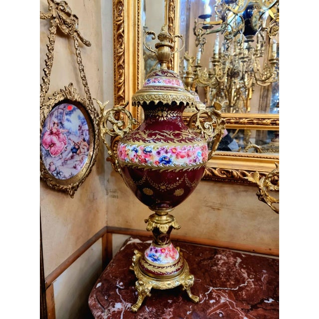 Elegant French Louis XV style 3-piece garniture set featuring a decorative centerpiece bowl-shaped vase accompanied by two...
