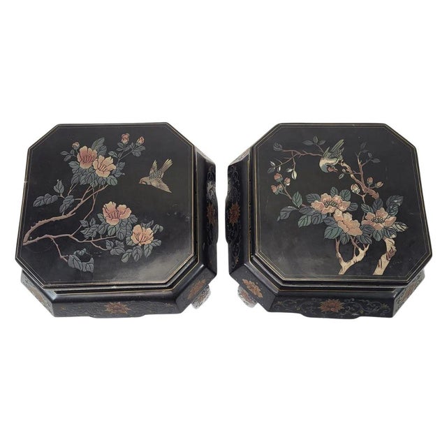 A refined pair of 20th-century Chinese black lacquer tambour stools, richly decorated in the Chinoiserie style. Each piece...