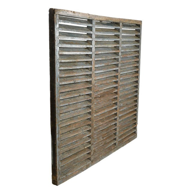 Large patinated wooden shutter. This piece is designed in the style of the selected designer and/or manufacturer