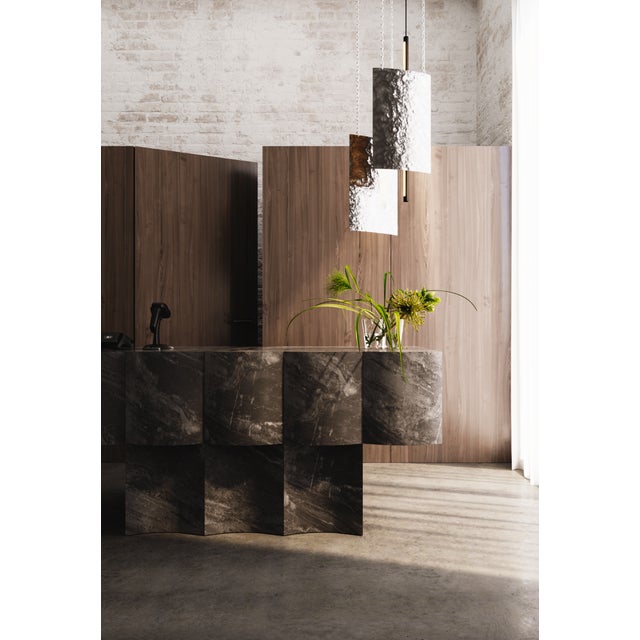 Svitlotin collection: where light meets shadow. These elegant curved pendant lights feature premium satin stainless steel...