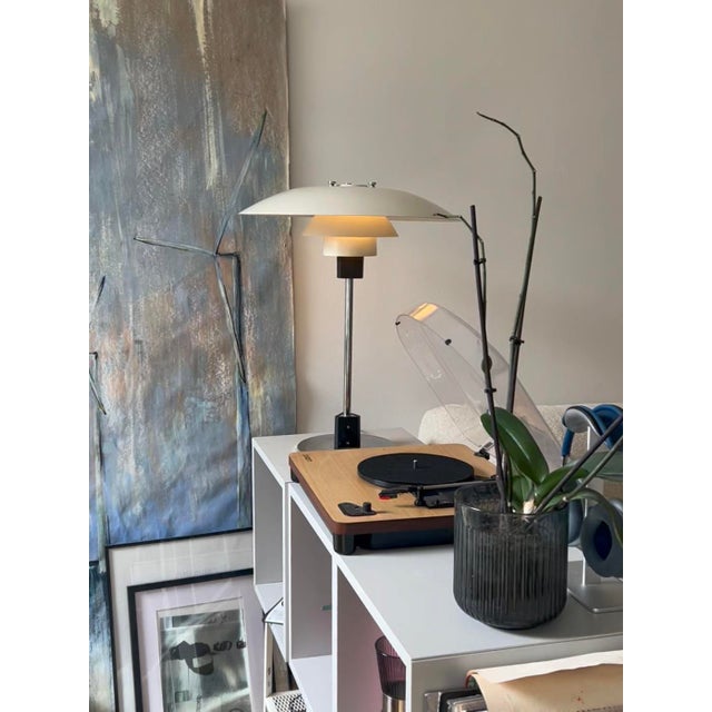 Bring one of the most iconic lamps in design history into your home. The PH 4/3 Table Lamp, designed by Poul Henningsen...