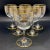 An antique rare Baccarat Louis XVI–style crystal service hand-blown, engraved and fire-gilded with neoclassical garlands...