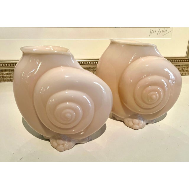 A pair of Pink Glass vases in the form of a shell. The vases are of good size and weight and would look stunning flanking...