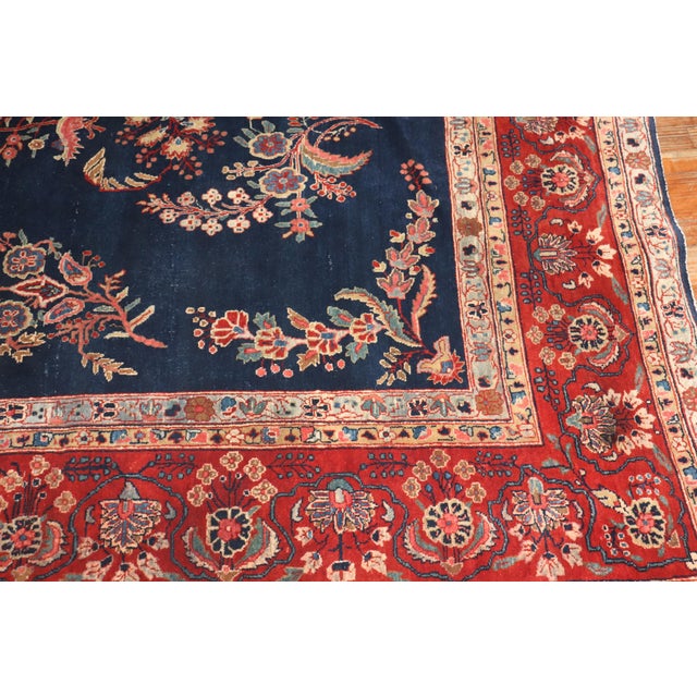 An authentic early 20th-century room size Persian Mohajeran Sarouk carpet in predominantly navy Measures: 8'9''x 11'11"...