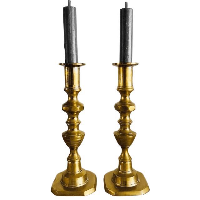 Beautiful set of two antique English brass pusher candlesticks from circa 1890. Originally, these brass candlesticks had a...