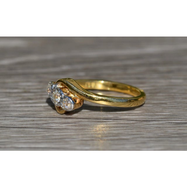 The Grove Avenue Ladies Vintage 18K Gold Trilogy Ring set with Diamonds. Crafted in 18 karat yellow gold, this bypass...