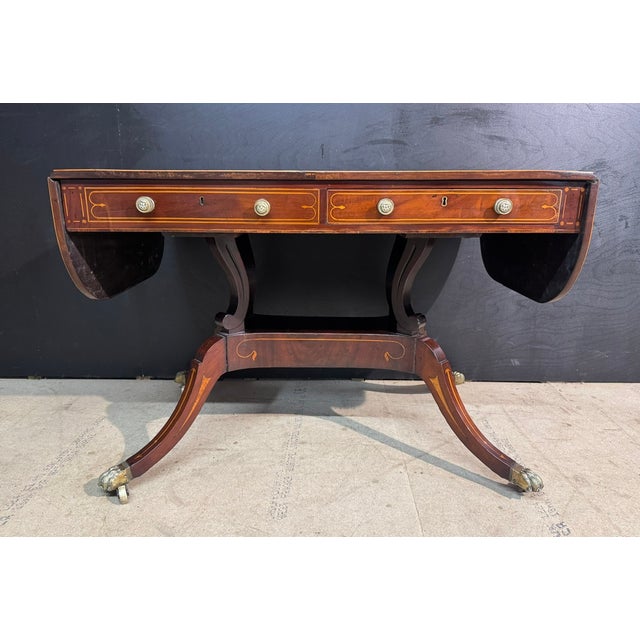 A Superb example of a Georgian Sofa Table. Made from Mahogany with inlays and a satinwood banding to the top. It is the...