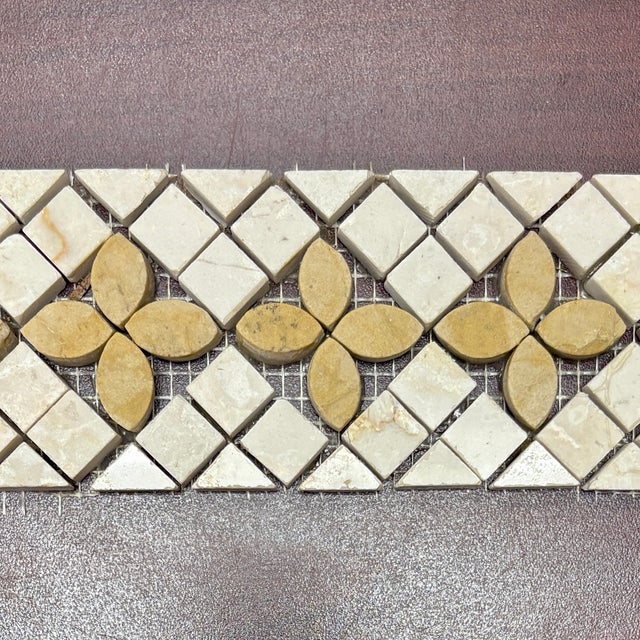 Polished botticino marble trebol decorative mosaic liner with giallo marble details. Suitable for use in vertical and...