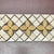 Polished botticino marble trebol decorative mosaic liner with giallo marble details. Suitable for use in vertical and...