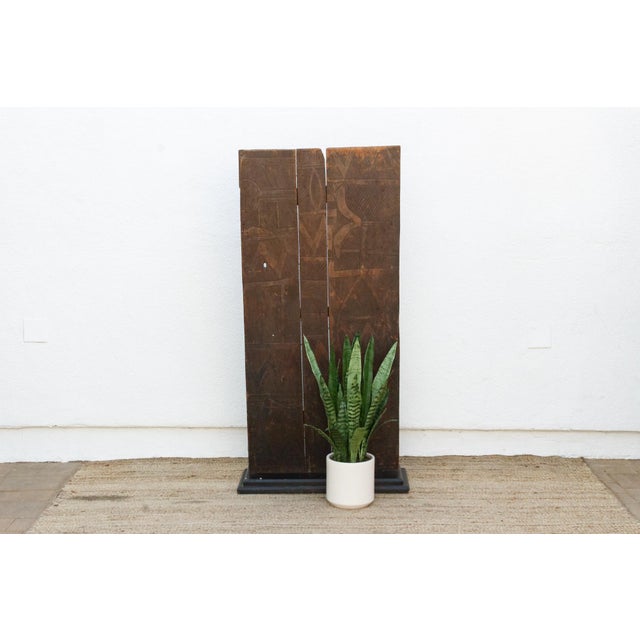 From the Nupe people of central Nigeria's Niger River region, this door is built from three narrow vertical planks joined...