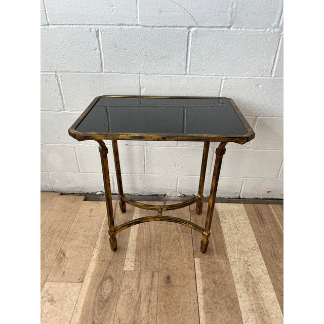 An elegant vintage faux bamboo side table executed in brass with refined neoclassical lines and a sophisticated Hollywood...