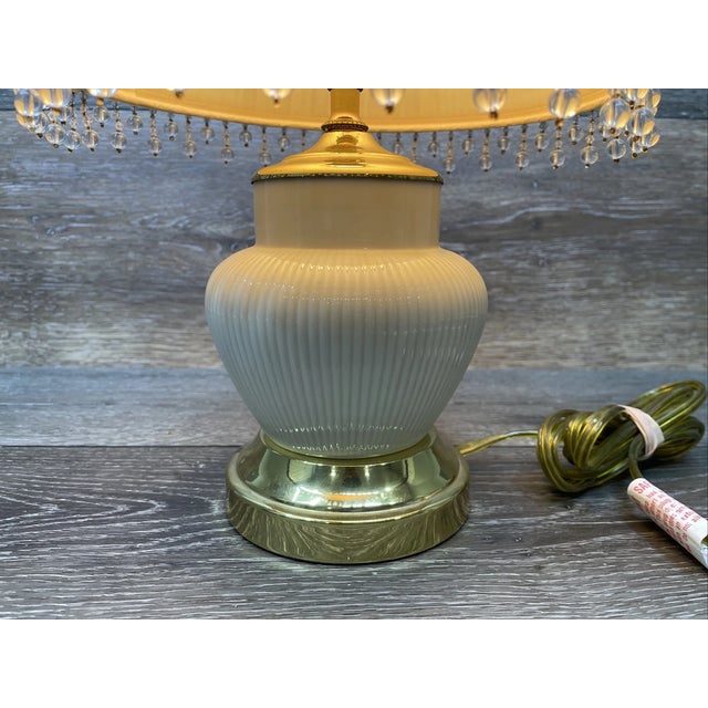 Beautiful vintage Mid-Century Modern porcelain and brass table lamp featuring a timeless blend of elegance and...
